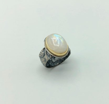 Rainbow Moonstone set in 18k gold bezel and reticulated silver band