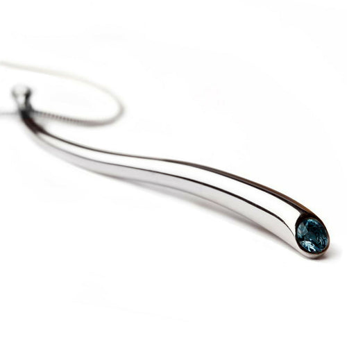 Long curving silver pendant with gemstone and silver detail