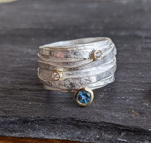 Curving Silver Wiggly Ring with Blue Topaz