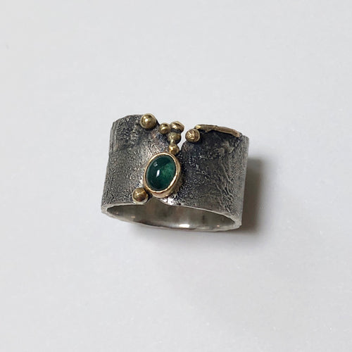 Oval Green Tourmaline in 18k gold bezel on Reticulated Oxidized Silver ring